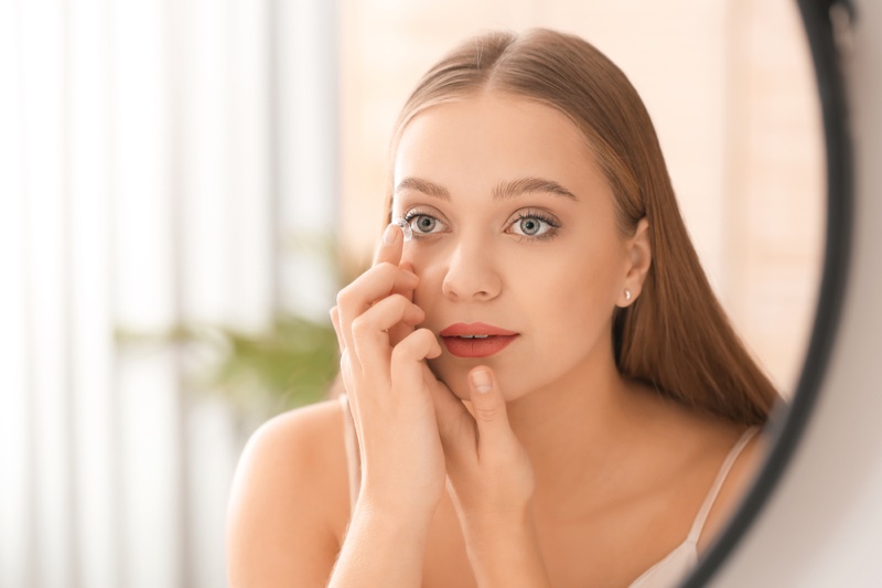 Blonde Woman Putting On Contact Lenses