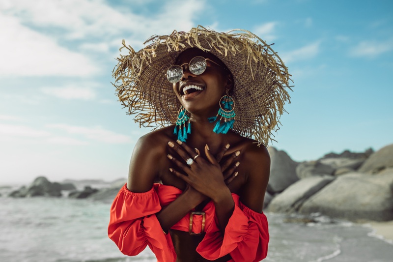 Happy Black Woman Beach Straw Hat Turquoise Earrings Red Top