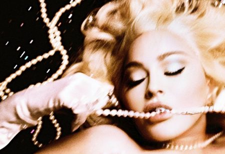 Madonna poses with pearl necklace, Neil Lane rings, and Carolina Amato gloves. Image: Courtesy of V Magazine / Steven Klein
