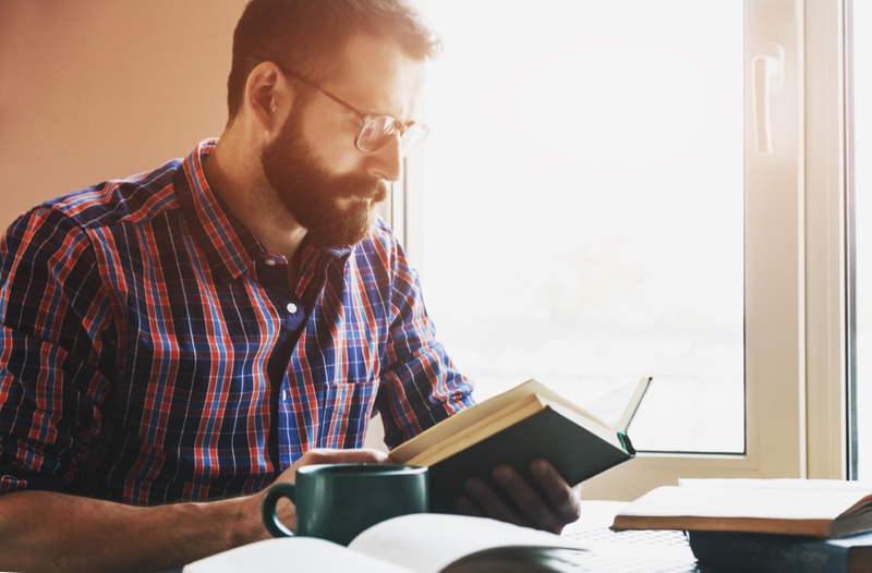 Man Plaid Shirt Reading Book Window