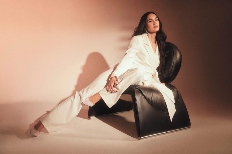 Megan Fox poses in white pantsuit from Boohoo x Megan Fox collaboration.
