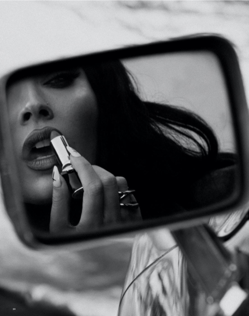 Megan Fox reapplies her lipstick in a car mirror. Photo: Daniella Midenge