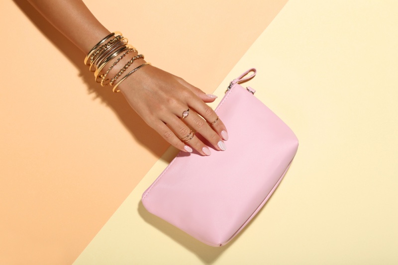 Model's Hand Gold Bangles Pink Bag