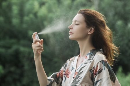 What Is The Best Skincare Routine For a Globetrotter? Woman Applying Face Mist Skin