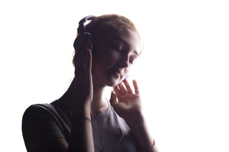 5 Ways to Occupy Yourself When Waiting for Your Hair and Beauty Appointment Woman Dreamy Headphones Shadow Image
