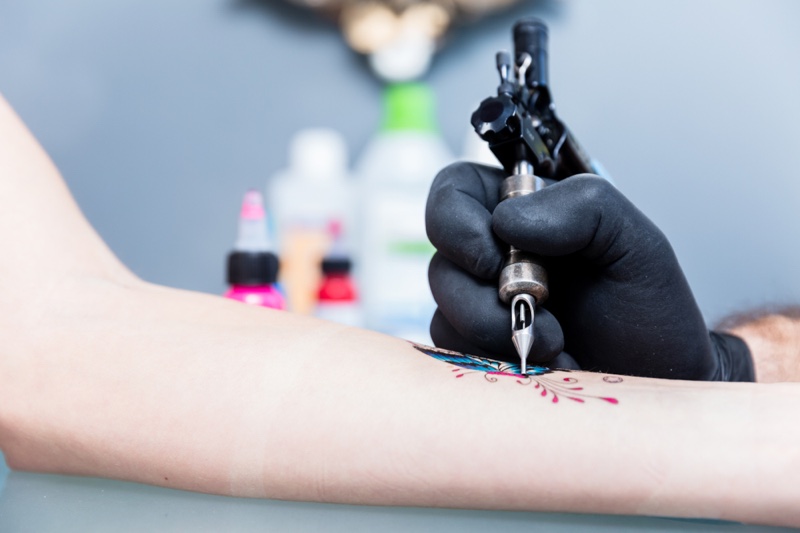 Woman Getting Butterfly Tattoo Arm