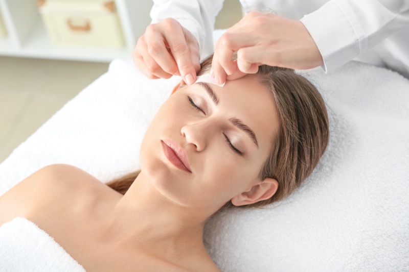 Woman Getting Eyebrows Waxed Professional