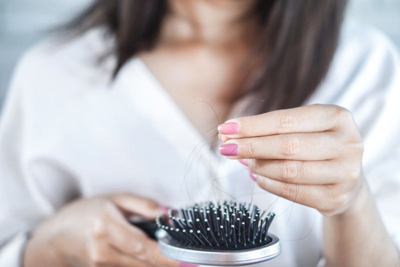 Woman Holding Hair Brush