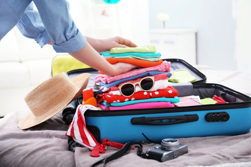 Woman Packing Luggage Suitcase