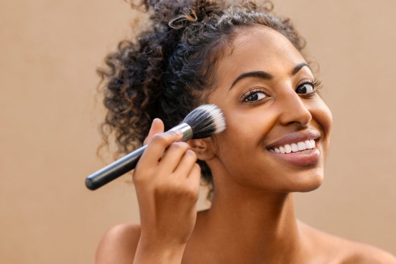 Woman Putting on Finishing Powder