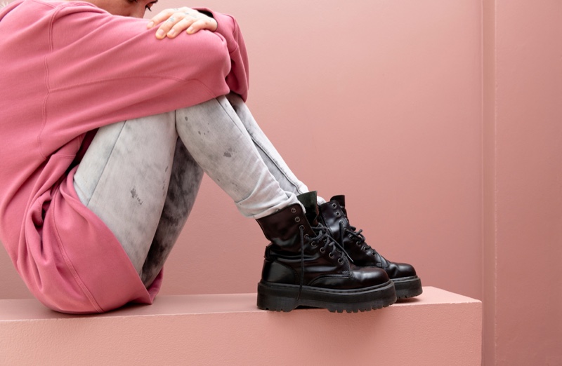 Young Woman Distressed Jeans Black Combat Boots