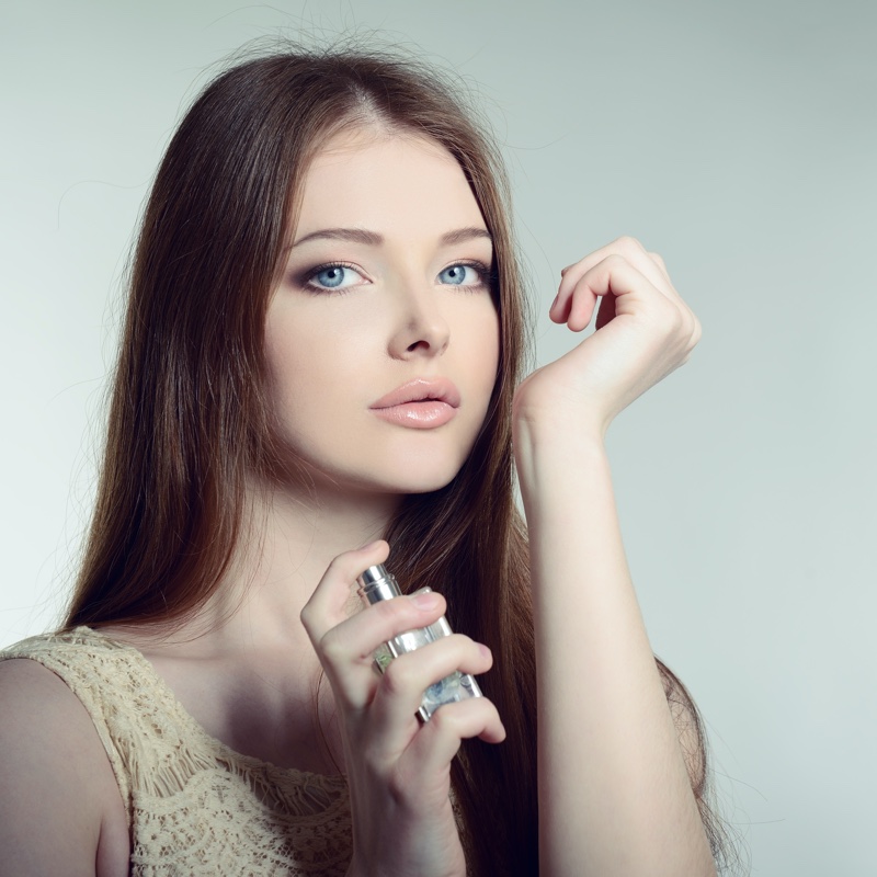 Beautiful Model Holding Fragrance Bottle