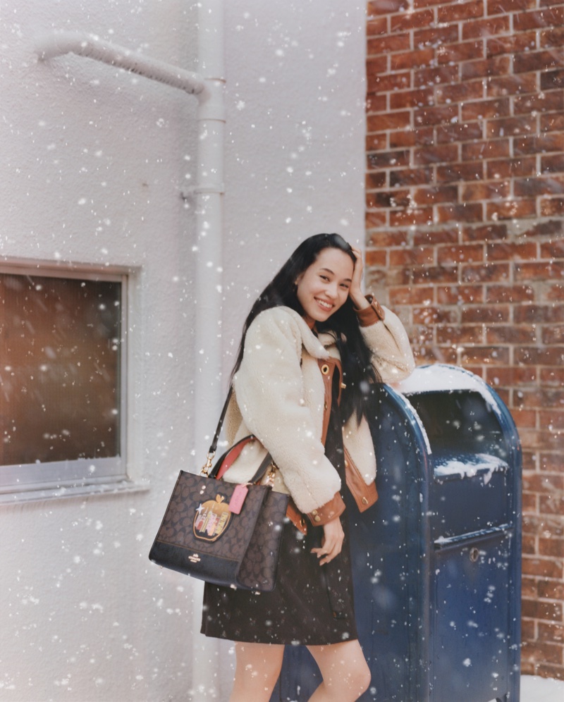 Posing in the snow, Kiko Mizuhara fronts Coach Holiday 2021 campaign.