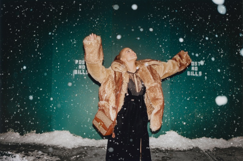 Coach ambassador Jennifer Lopez poses in the snow for the brand's Holiday 2021 campaign.
