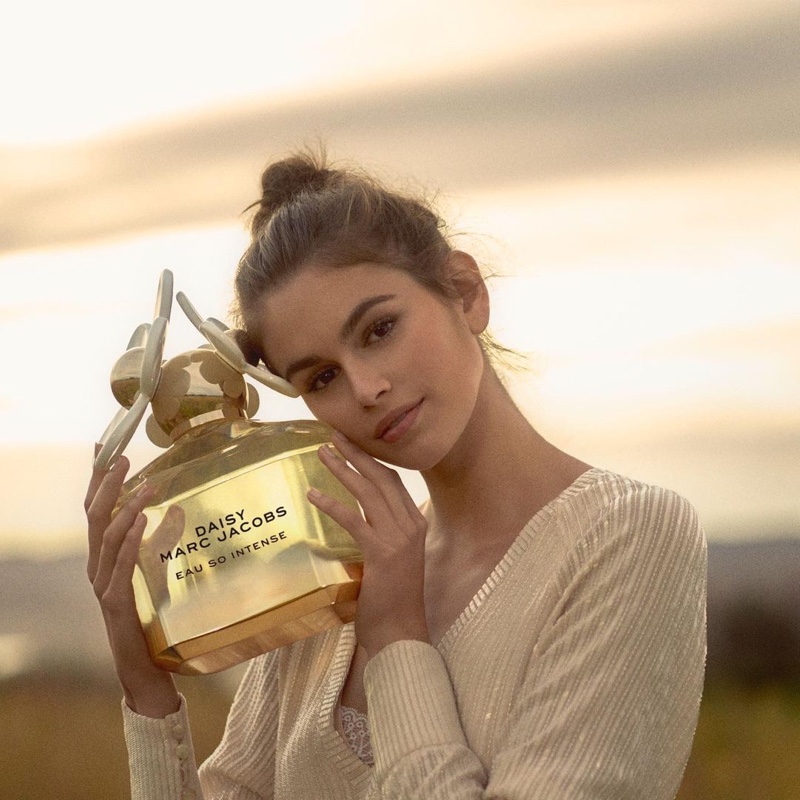 Model Kaia Gerber poses with Marc Jacobs Daisy Eau So Intense eau de parfum bottle. Photo: Alasdair McLellan