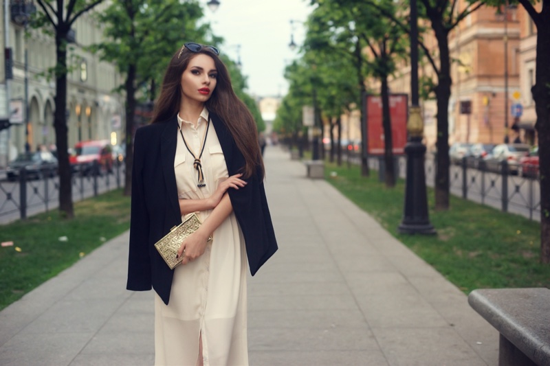 Woman Black Blazer White Dress Gold Clutch Bag