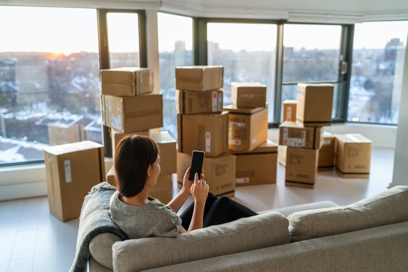 Woman Couch Moving Boxes