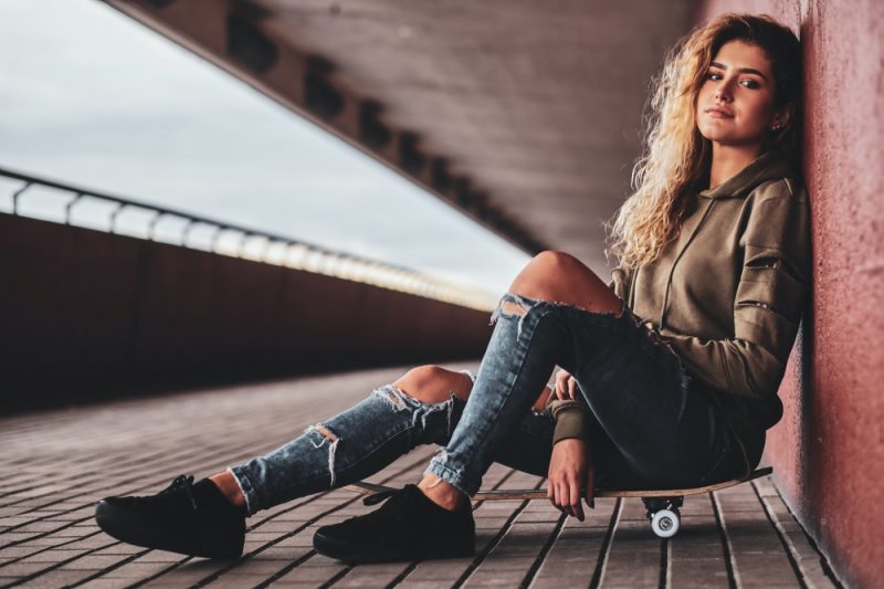 Woman Wearing Ripped Jeans Hoodie