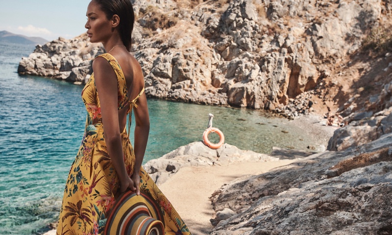 Joan Smalls wears Zimmermann Tropicana dress from the brand’s resort 2022 swim collection.