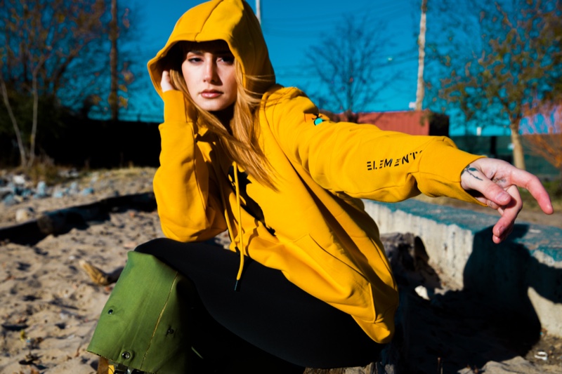 Musician Annalise Azadian wears hoodie from Save the Duck x Compound collaboration.