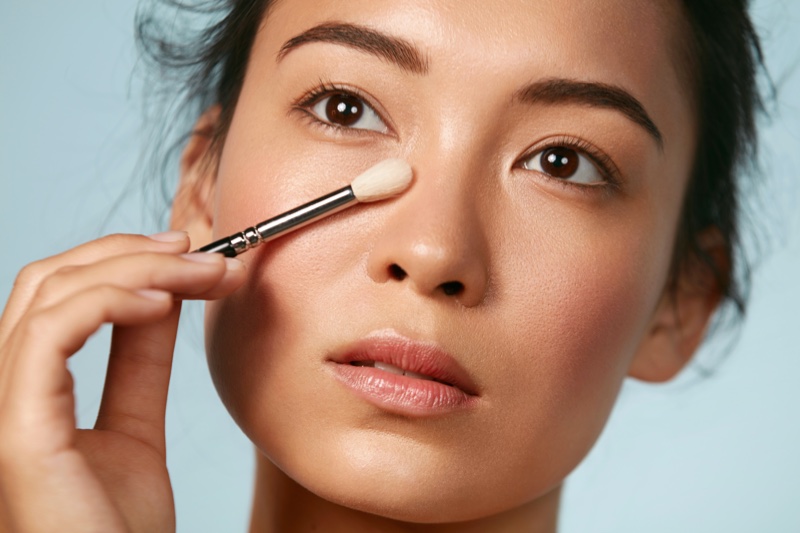 Asian Woman Applying Eye Makeup