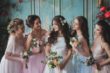 How to Pick Your Bridesmaids & Avoid Wedding Drama Bride Smiling Bridesmaids Flowers