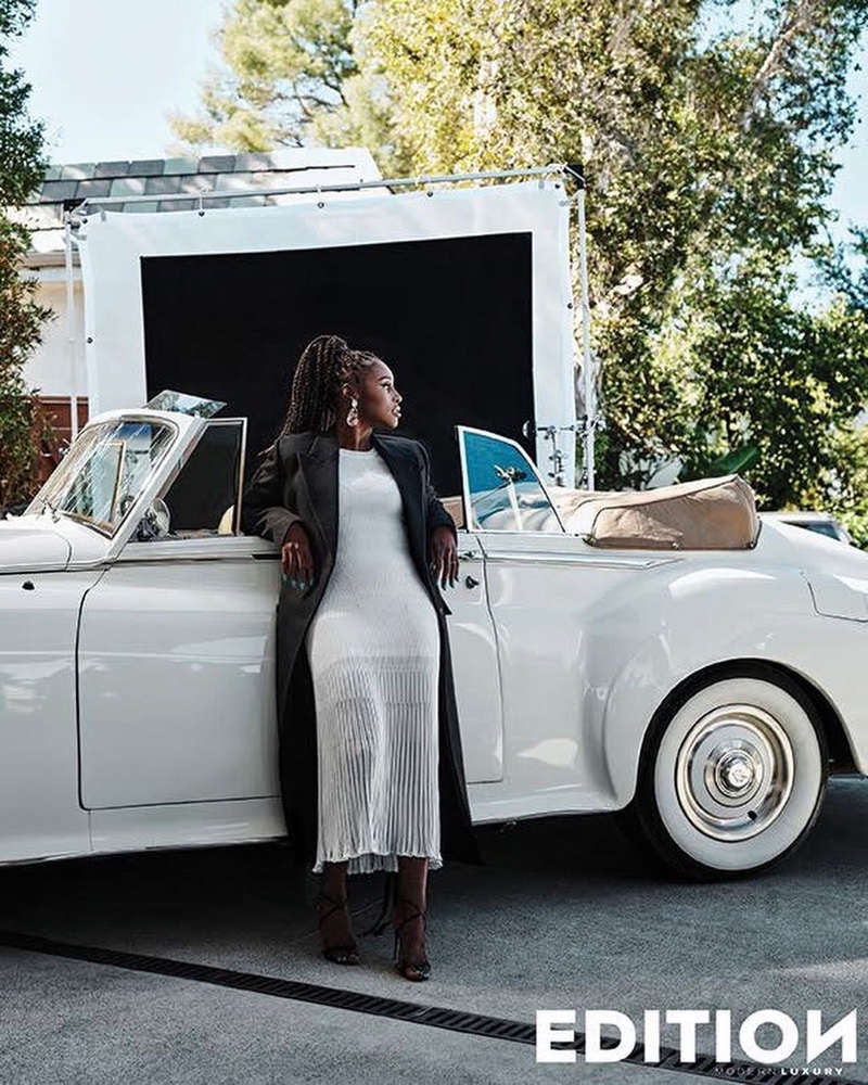 Issa Rae poses next to a convertible in an Alexander McQueen look. Photo: JD Barnes / Edition