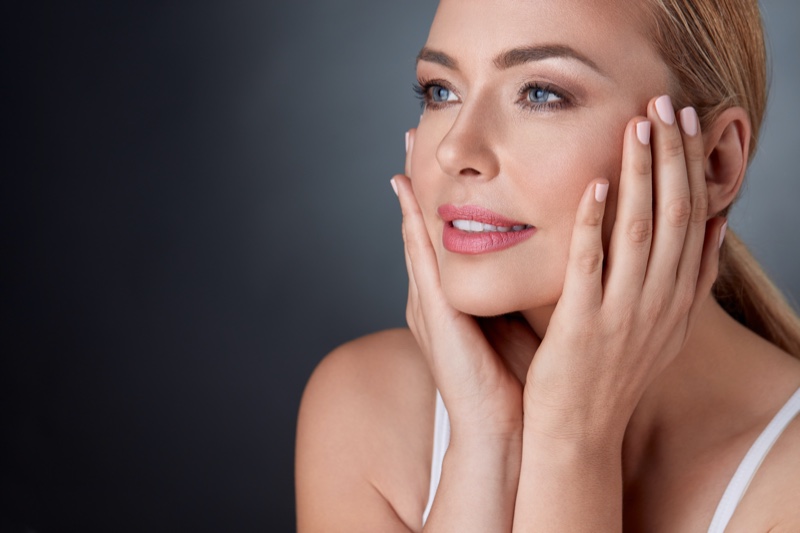 Mature Woman Touching Face