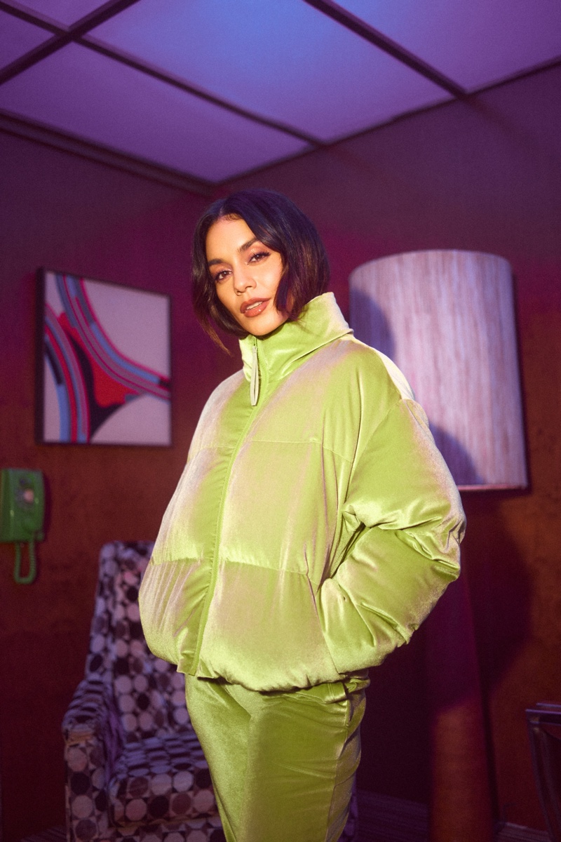 Actress Vanessa Hudgens wears a green puffer jacket from Fabletics' velour collection.