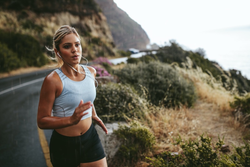 Woman Running Road Listening Earphones