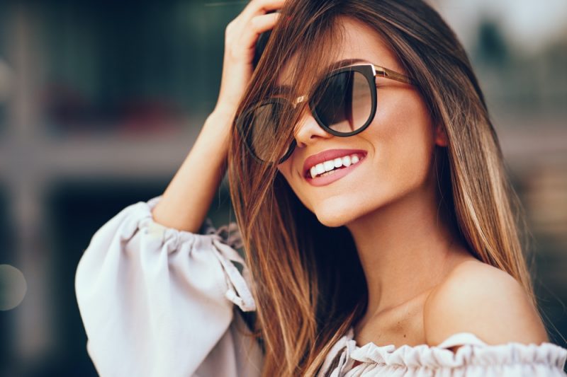 Woman Smiling Wearing Sunglasses
