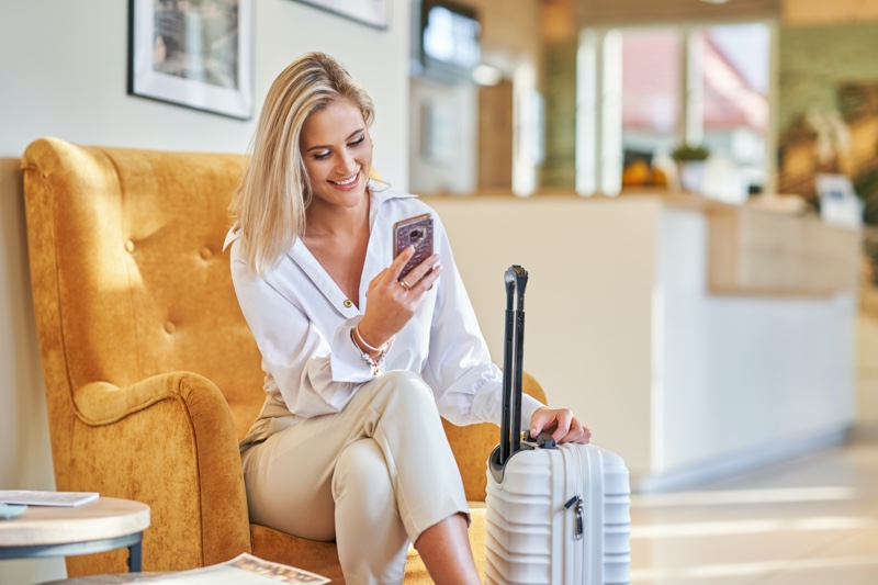 Woman Suitcase Checking Phone