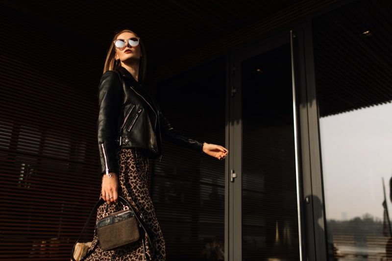 Woman in Leather Jacket Sunglasses Small Purse Sun Going Down