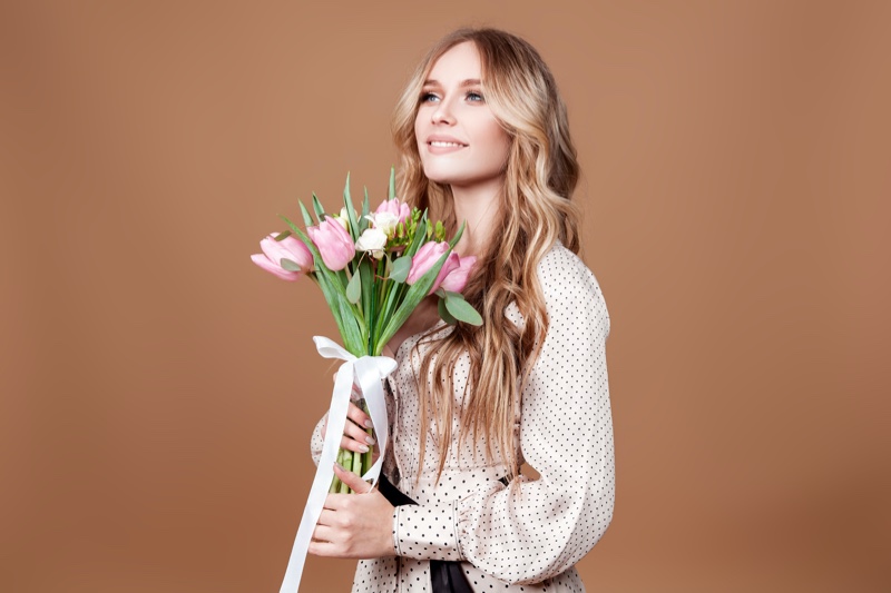 Blonde Woman Holding Flowers Happy