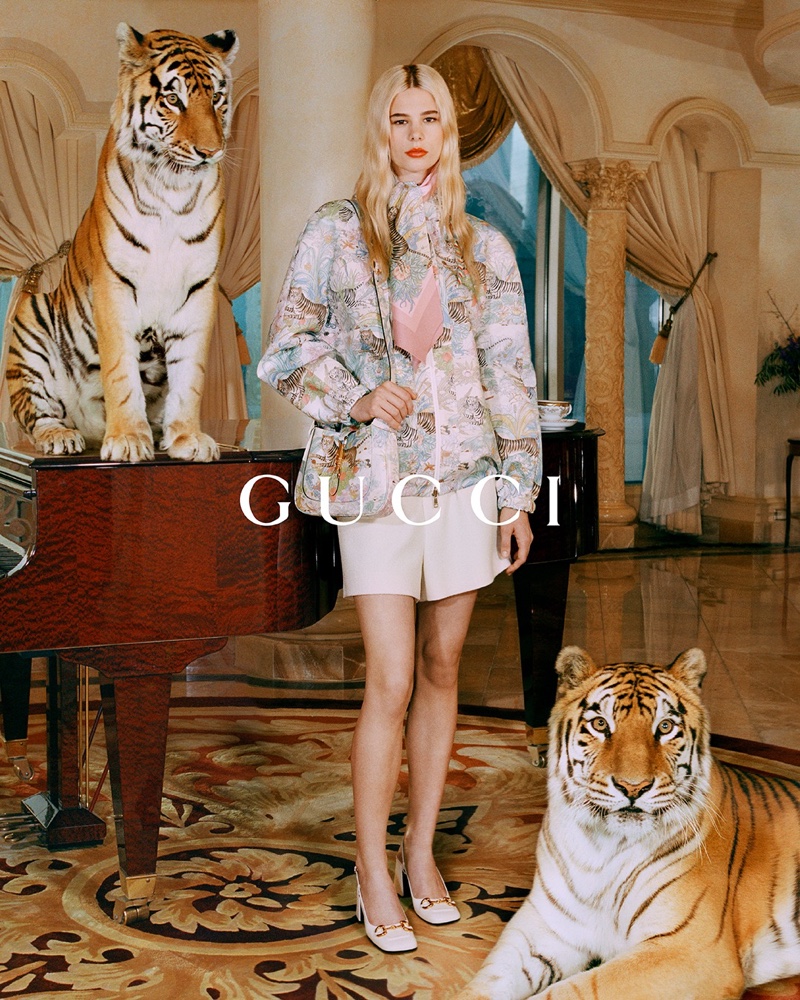 Models pose with real life tigers for Gucci Year of the Tiger campaign.