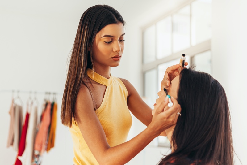 Makeup Artist Yellow Top Working Client