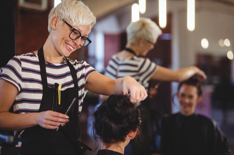 Smiling Hairstylist Touching Client's Hair