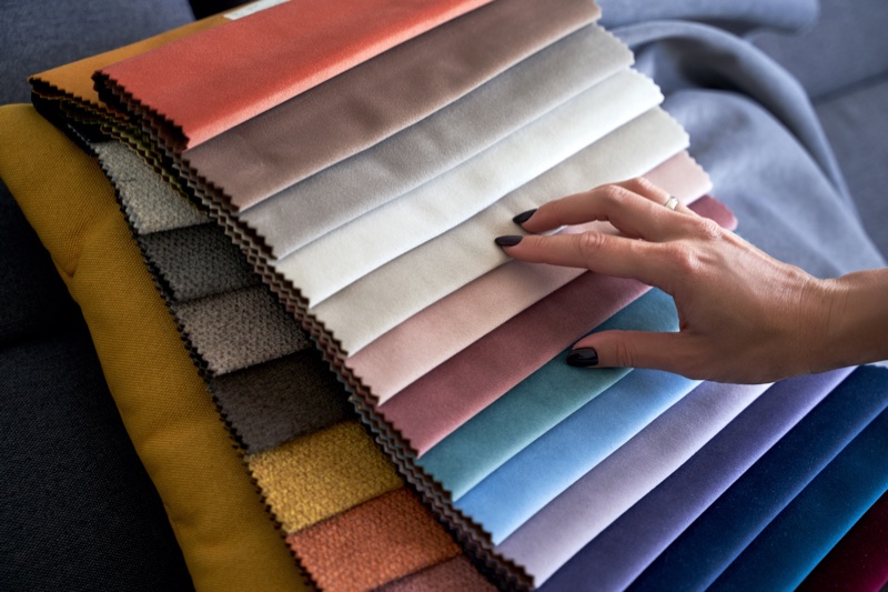 Woman Picking Upholstery Fabric Swatches