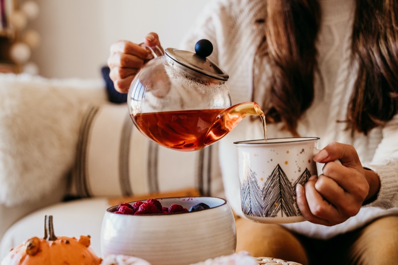 Woman Powering Tea Cup Pot Raspberries