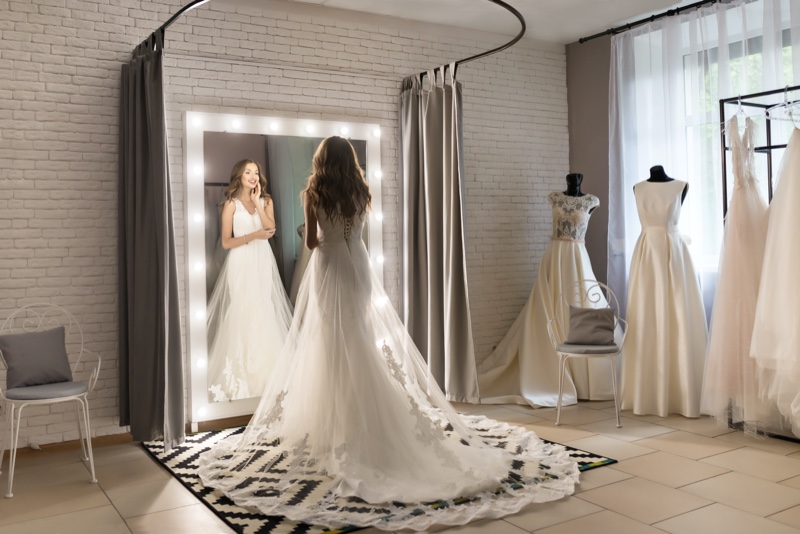 Woman Trying Wedding Dress Mirror Lights