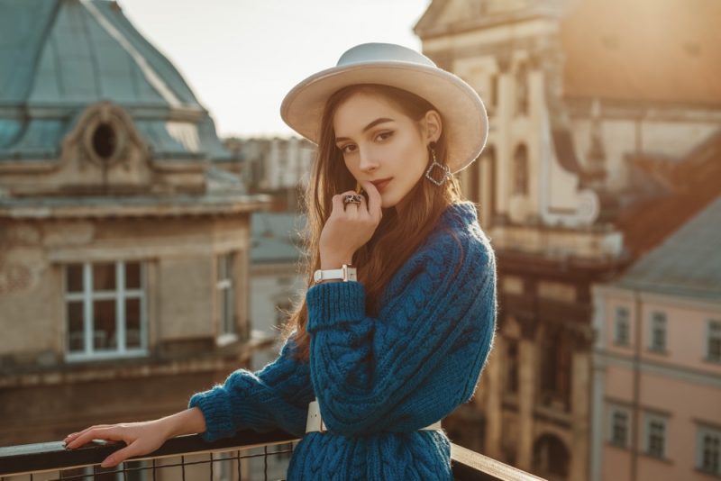 Woman Wearing Fedora Jewelry Belted Cardigan Sweater