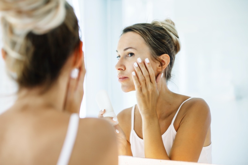 Blonde Woman Checking Skin Mirror