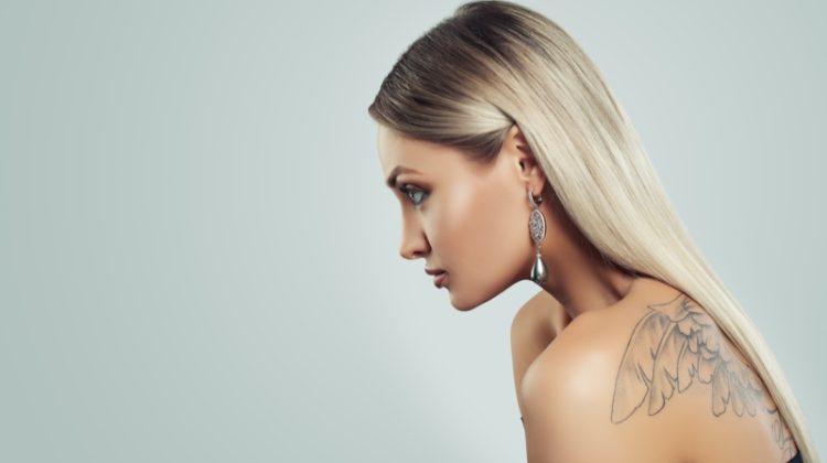 Side View Blonde Model Earring Wings Tattoo