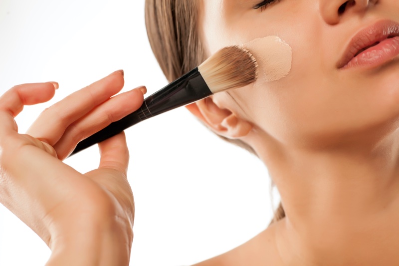 Woman Applying Liquid Foundation Brush Makeup