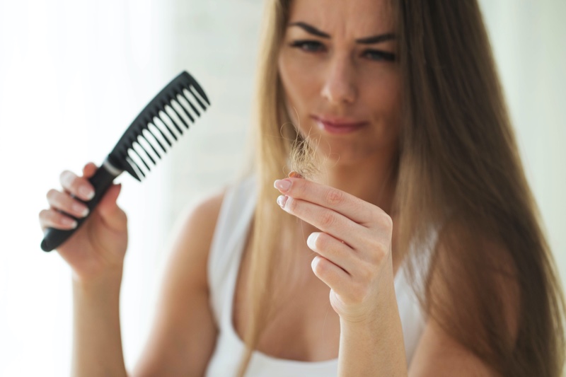 Woman Checking Hair Loss Comb