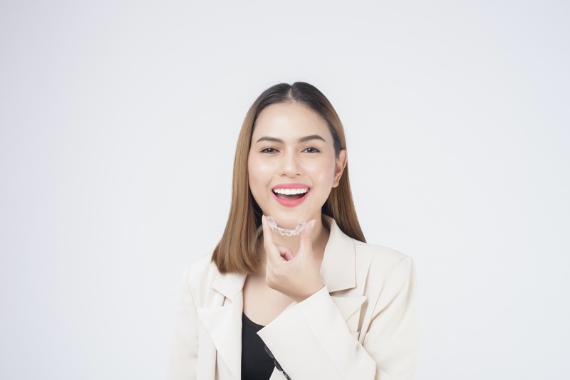 Woman Holding Invisalign Braces