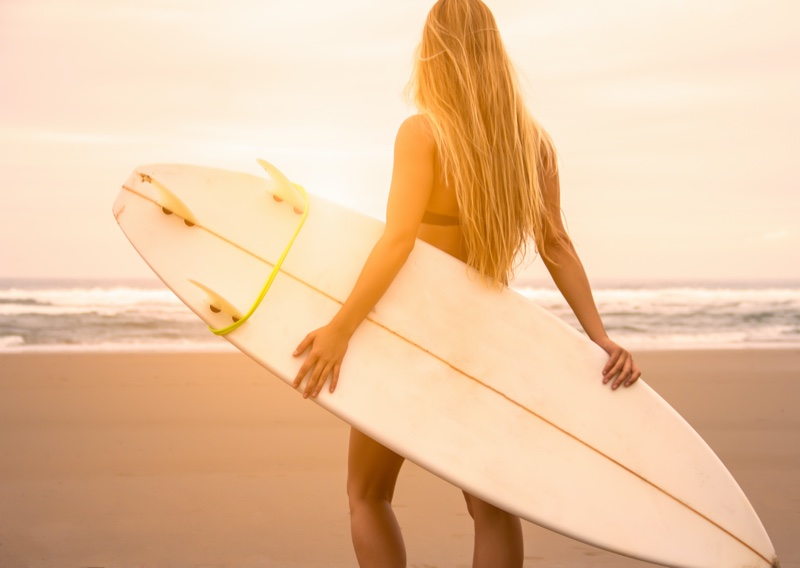 Woman Holding Surf Board Back