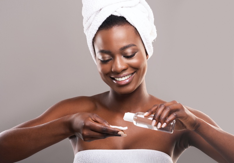 Black Woman Applying Makeup Remover Cotton Pad
