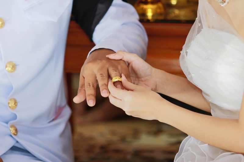 Bride Putting Gold Ring Groom