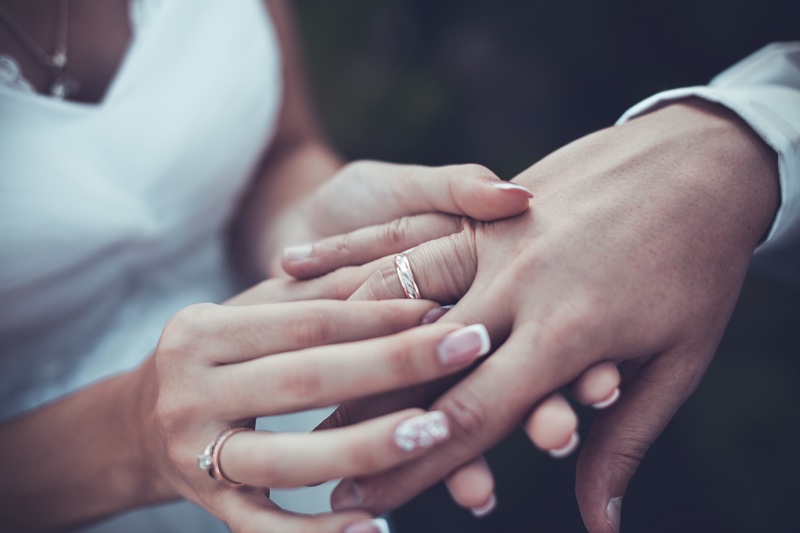 Couple Wedding Rings Bride Placing Ring Groom's Finge